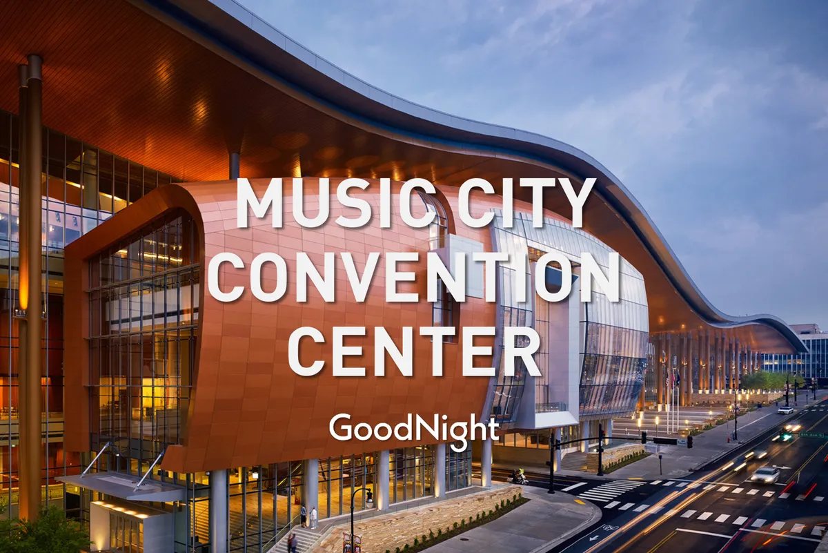 A bold view of the Music City Center with its unique architectural roofline and expansive glass windows, bustling with visitors. The energetic scene hints at conventions, exhibitions, and community events all taking place in a central Nashville hub.